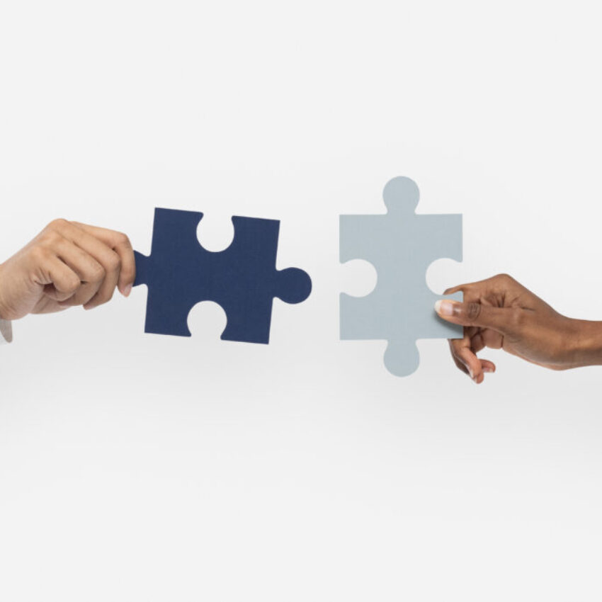 Hands holding puzzle business problem solving concept Hands holding puzzle business problem solving concept